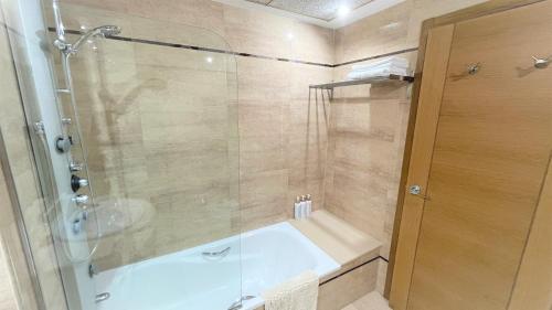 a bathroom with a shower and a bath tub at BEACH VALENCIA 13 - Luxury Beachfront Apartament in Valencia