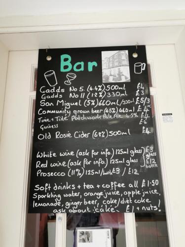a sign on the door of a bar with writing on it at Rosslyn Court in Margate