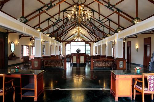 a large room with tables and chairs and a chandelier at Tea county in Munnar