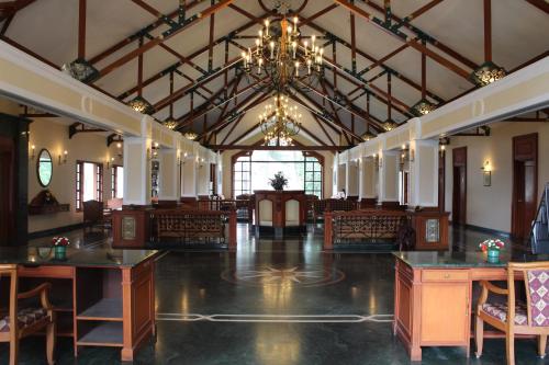 a large room with tables and chairs and a chandelier at Tea county in Munnar
