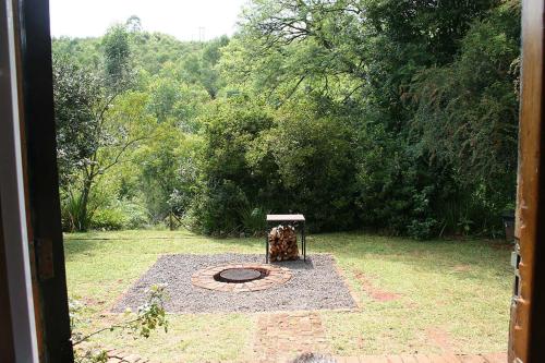 a garden with a fire pit in the grass at Sabie Star in Sabie