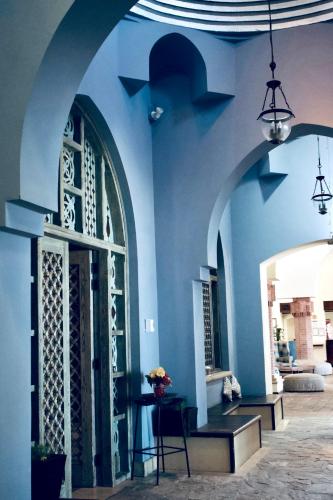 a blue building with a door and a bench at Radisson Blu Resort El Quseir in Quseir