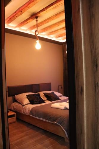 a bed in a room with a loft at MERLIN Apartments in Zamość