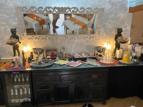 a table with food on it with a mirror at El Chili Boutique Hotel in Barbate