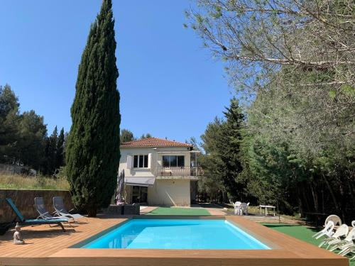 a villa with a swimming pool and a house at L'Olivier in Saint-Mitre-les-Remparts