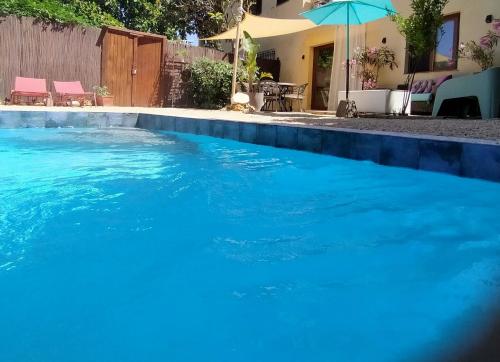 a large pool of blue water in front of a house at Casa Francesca Altea piscina y aparcamiento privado in Altea