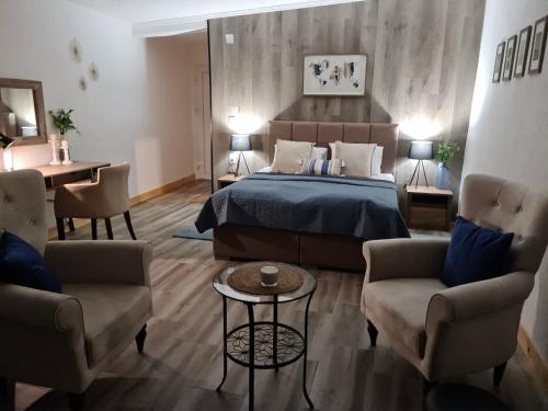 a bedroom with a bed and a desk and chairs at Apartments Zec in Čanj