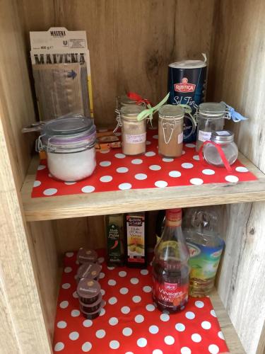 a wooden shelf with food and drinks in a drawer at Un séjour entre Nîmes et Montpellier in Souvignargues
