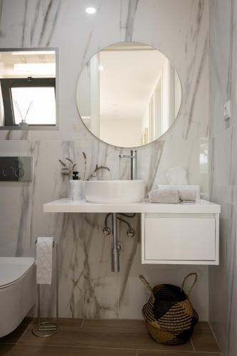 a bathroom with a sink and a mirror at Casa dos Bernardos in Trancoso