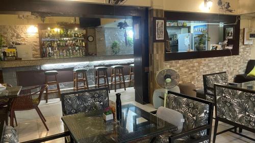 a restaurant with a bar with tables and chairs at Sofia Hotel in Hua Hin