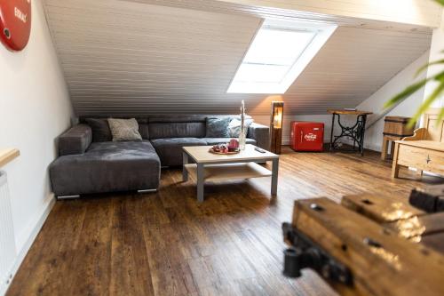 a living room with a couch and a table at Ferienwohnung Kaufbeuren in Kaufbeuren