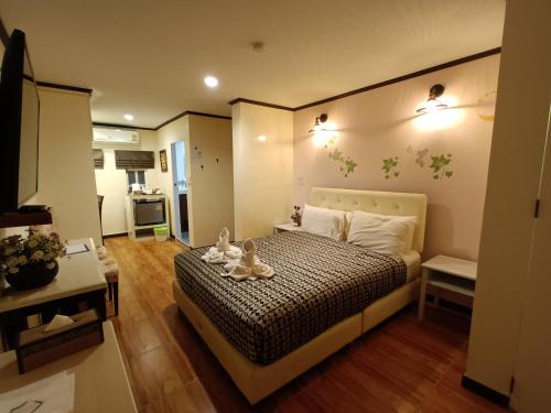a bedroom with a bed with two stuffed animals on it at Cana Boutique Hotel in Bangkok