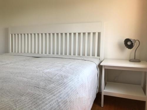 a bedroom with a bed and a nightstand with a lamp at Ferienwohnungen Tinymoon in Feldbach