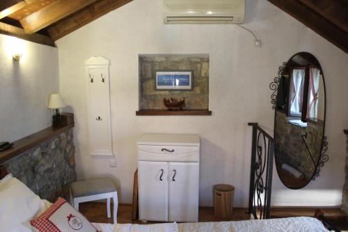 a room with a bed and a mirror at Stone house Castellum in Kaštela