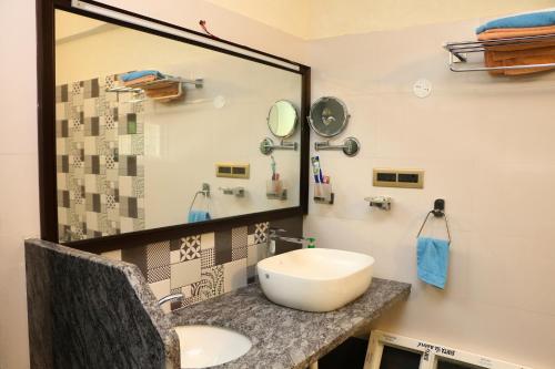 a bathroom with a sink and a mirror at Penthouse 2BHK with Bathtub and Terrace in Puducherry