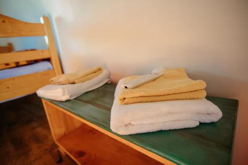 two stacks of towels sitting on top of a counter at Popas 8 Odăi in Poiana Aiudului
