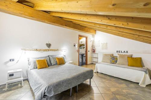 1 dormitorio con 2 camas y techos de madera en Le Quattro Stelle Villa, en Cardano al Campo