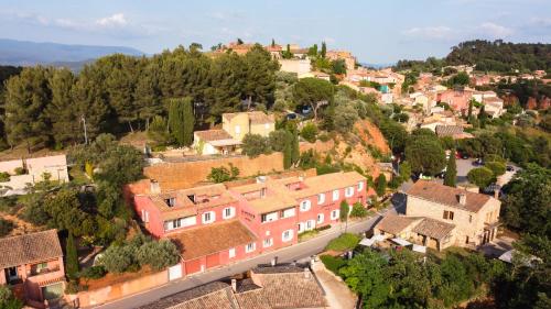 a small town with a large building on top of it at La Maison des Ocres in Roussillon