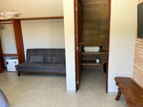a living room with a couch and a sink at Casa Praia Patacho in Pôrto de Pedras