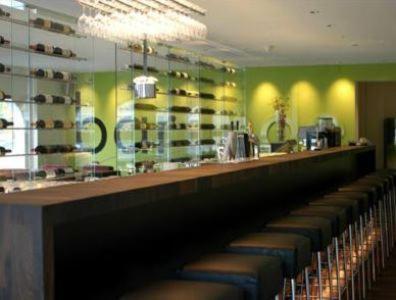 a bar with a row of seats in a restaurant at Landhotel Linde Fislisbach in Baden