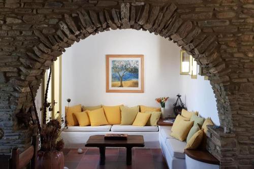 a living room with a white couch with yellow pillows at Villa theassis in Arnados
