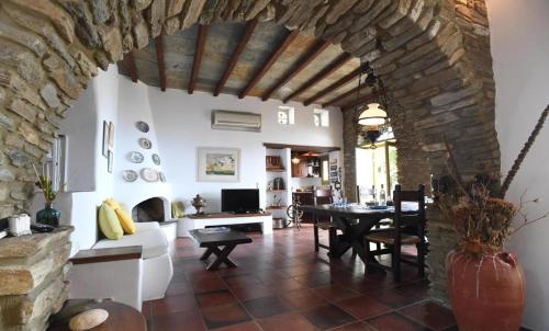 a living room with a table and a stone wall at Villa theassis in Arnados