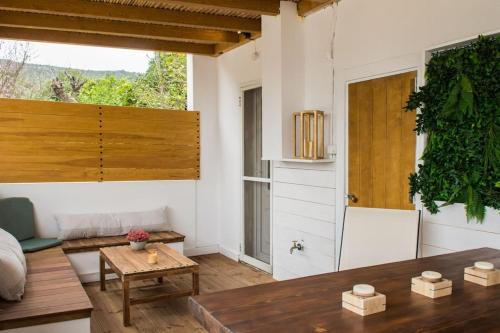 a living room with a wooden table and a door at Alfa house w/ view & barbeque in Pythagorion in Pythagoreio