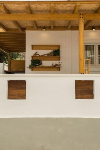 a room with a white counter with wooden ceilings at Alfa house w/ view & barbeque in Pythagorion in Pythagoreio