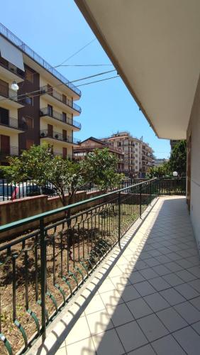 a walkway next to a building with a fence at R Family in Acireale