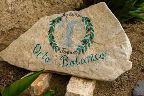a rock with a wreath on it sitting on the ground at Agriturismo le Fontane - Lago di Bolsena in Grotte di Castro