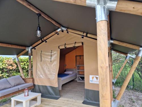 une tente avec un lit et une table dans l'établissement Camping les Lavandes, Castellane, à Castellane