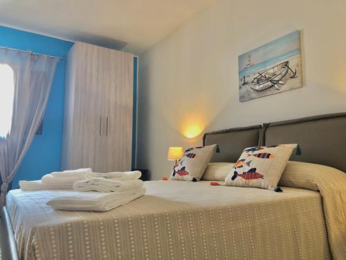 a bedroom with two beds with towels on them at Xenia House in Lascari