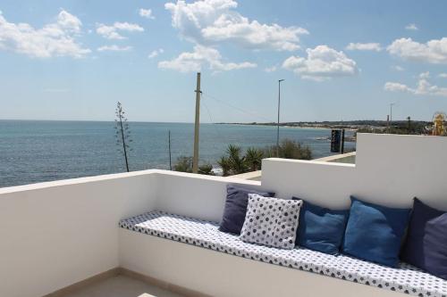 a bench on a balcony with a view of the ocean at Casa fronte mare a Torre Vado 2 in Torre Vado