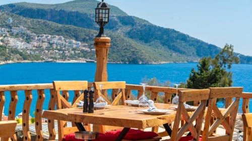 a wooden table with a lamp on top of a balcony at Old Trading House in Kalkan