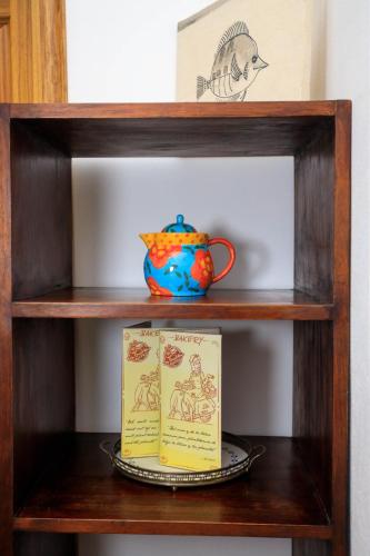 a book and a vase on a shelf at Kalawala in Puerto Viejo