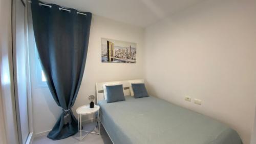 a small bedroom with a bed and a window at PaulMarie Gigantes Fantastic View in Puerto de Santiago