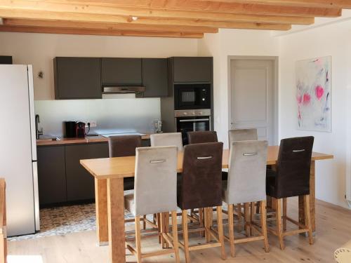 a kitchen with a wooden table and chairs at Villa au lac du Salagou - 10 pers in Octon