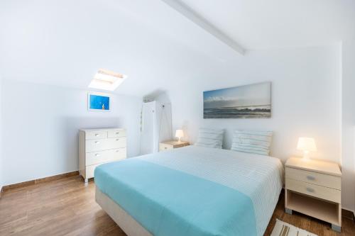 Ένα ή περισσότερα κρεβάτια σε δωμάτιο στο Casa da Tita Alvor