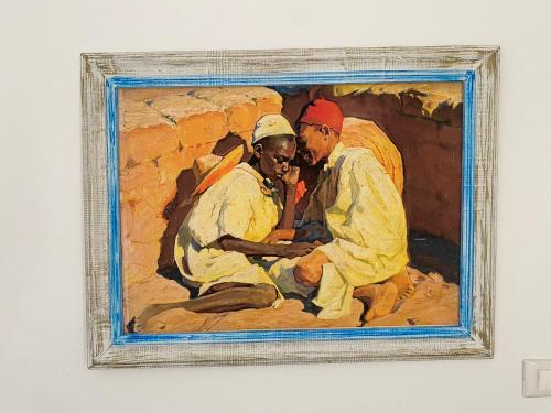 a painting of a man and a woman at Dar Ezzahra in Tozeur