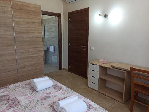 a bathroom with a bed and a desk and a mirror at La Campagnola in Locogrande