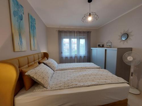 a bedroom with a bed and a window at Family apartment Cathy in Galižana