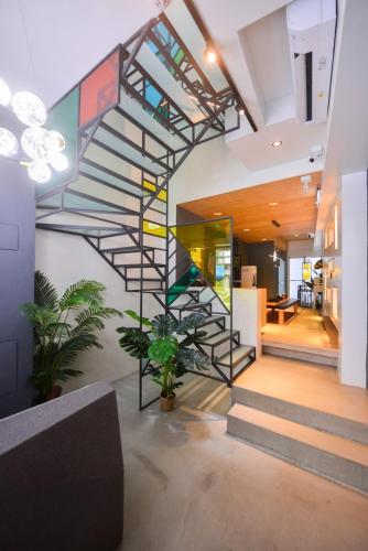 a spiral staircase in a house with a lobby at Min-sheng Art homestay in Tainan
