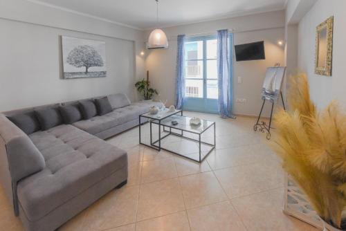 a living room with a couch and a table at DEJA BLUE Maisonette in Kokkari