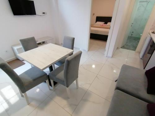 a dining room with a table and chairs at Olea in Tivat