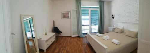 a bedroom with a bed and a dresser and a mirror at Villa Allegra 1 in Lovran