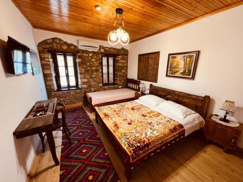 a bedroom with two beds and a wooden ceiling at KRIS Guesthouse in Berat