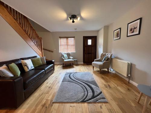 a living room with a couch and a rug at Stable Court Apartments in Antrim