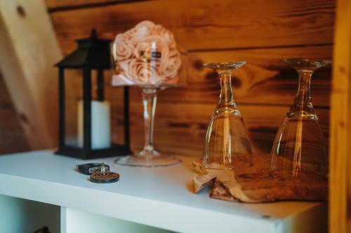 une étagère avec trois vases en verre et une lampe sur celle-ci dans l'établissement Glamping alp hut in camping Garden Park, à Radovljica