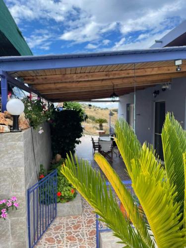 a porch of a house with a wooden pergola at Villa Castle Sea View in Paralion astros