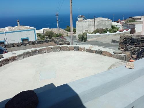 a large concrete patio with the ocean in the background at La casa dei nonni in Pantelleria